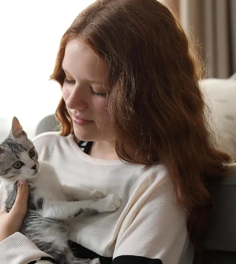 A woman holding her cat